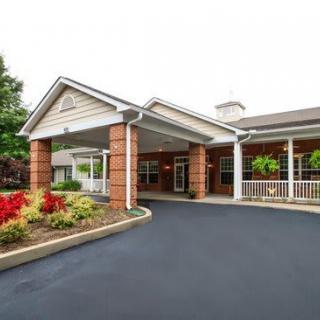 An inviting entrance to a well-maintained building with landscaped surroundings.