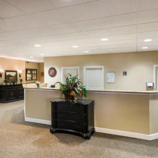 A tidy reception area with a desk and comfortable seating.