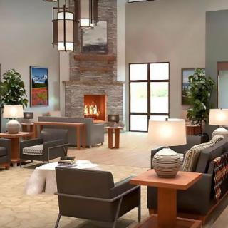 A modern and cozy living room featuring a central fireplace, comfortable seating, and stylish decor.