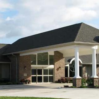 A modern building with a prominent entrance and columns.