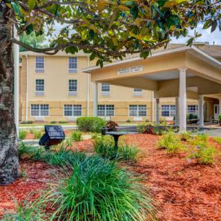 A hotel exterior with well-maintained landscaping and garden.