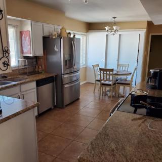 Modern kitchen with stainless steel appliances and a cozy dining area.