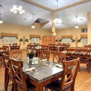 A spacious dining area with neatly arranged tables and elegant lighting.