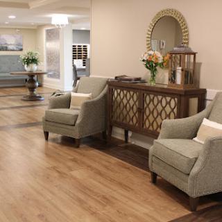 A cozy seating area in a modern lobby, featuring stylish armchairs and decorative elements.