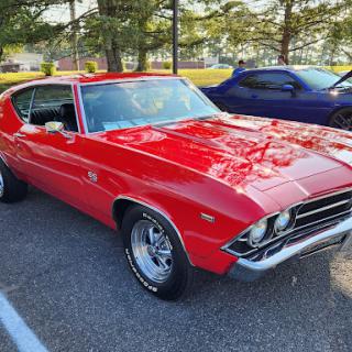 A stunning red Chevrolet Chevelle, showcasing classic American muscle car design.