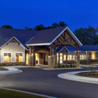 A well-lit building with an inviting entrance at night.
