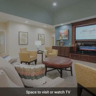 A modern living room with comfortable seating and a large TV.