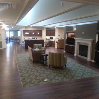 A spacious and inviting community living area featuring comfortable seating and modern amenities.