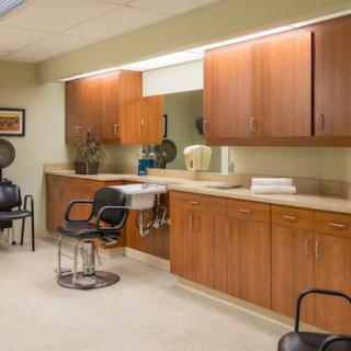 A well-organized hair salon interior featuring stylish chairs and cabinetry.