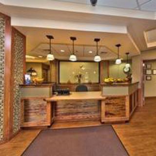 A reception area featuring a wooden desk and modern lighting.