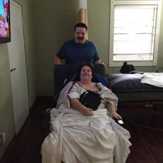A caregiver assisting a patient in a healthcare setting.