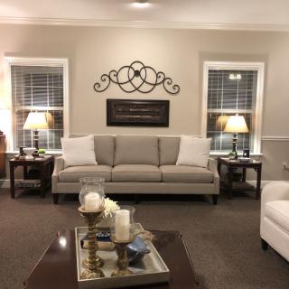 A cozy living room with a neutral-toned sofa, a decorative coffee table, and ambient lighting.
