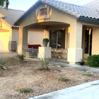 A cozy residential house with a welcoming porch and landscaped front yard.