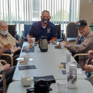 A group of elderly individuals enjoying a social gathering at a care facility.