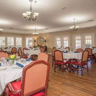 An elegant dining area with neatly arranged tables and chairs.