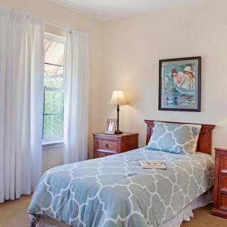 A cozy bedroom with a single bed and decorative elements.