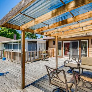 A spacious backyard patio with a wooden pergola and outdoor seating.