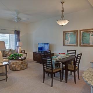 A cozy living and dining area featuring elegant furniture and tasteful decor.