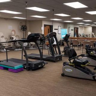 A well-equipped gym with treadmills and stationary bikes, ready for workouts.