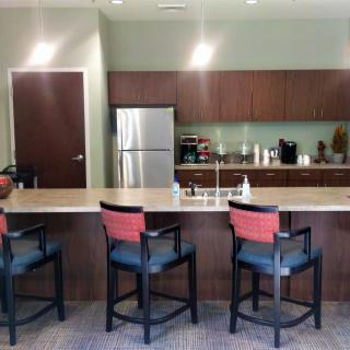 Modern kitchen with bar stools and a spacious countertop.