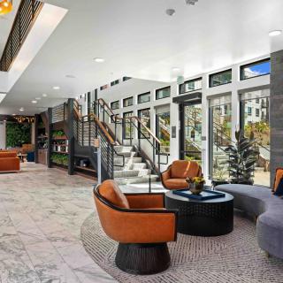 A modern lobby interior with comfortable seating and large windows allowing natural light.
