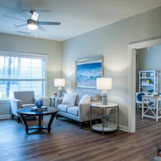 A modern living room featuring comfortable seating, natural light, and stylish decor.