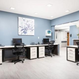 A modern office space with multiple workstations and computers.