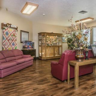 A cozy living room with comfortable seating and decorative elements.