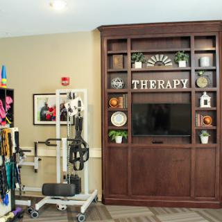 A therapy room equipped with exercise tools and a welcoming interior.
