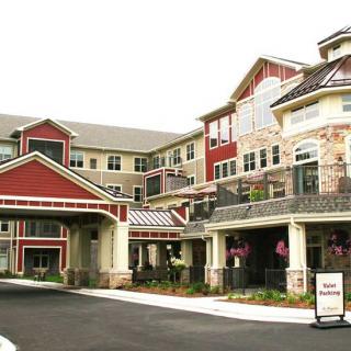 Entrance to a modern residential building with red and beige accents.