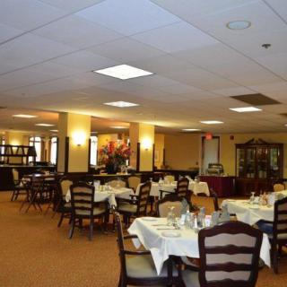 An elegant dining area with neatly arranged tables and chairs.