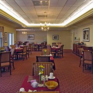 Cozy restaurant dining area with neatly arranged tables and elegant lighting.