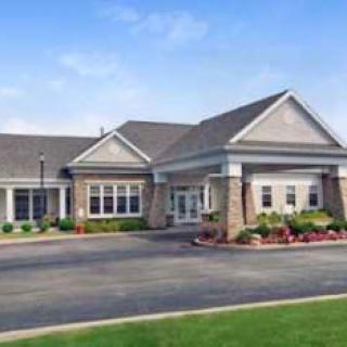 A modern commercial building with a welcoming entrance and landscaped surroundings.