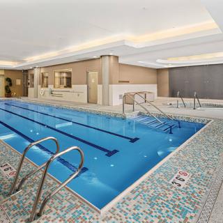 A serene indoor swimming pool featuring modern design and luxury amenities.