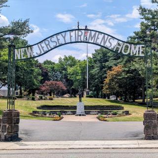 Entrance to the New Jersey Veterans Home, surrounded by lush greenery.