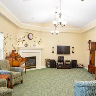 Spacious living room with cozy seating, a fireplace, and entertainment center.