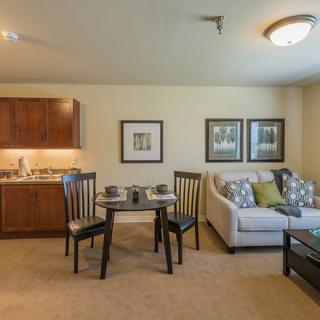 A cozy apartment living room with a small dining area and comfortable furniture.