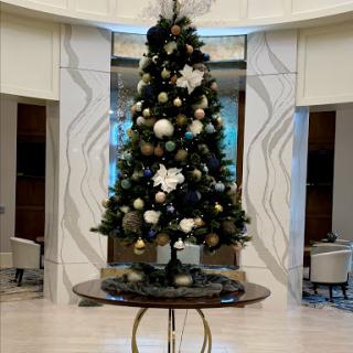 A beautifully decorated Christmas tree in a modern interior setting.