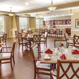 An elegantly decorated dining room with neatly arranged tables and chairs.