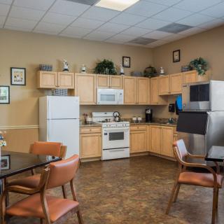 A communal kitchen area with modern appliances and seating.