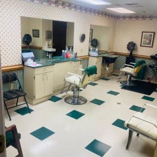 Interior view of a classic barbershop with chairs and mirrors.