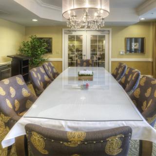 A stylish dining room with an elegant table setting and chandelier.