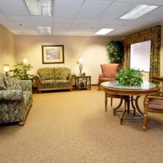 A cozy waiting room with comfortable seating and decorative plants.