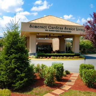 Entrance to Somerset Gardens Senior Living with well-maintained landscaping.