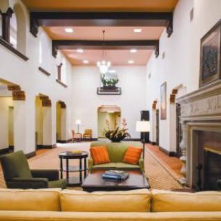 A spacious and elegantly decorated lobby with comfortable seating and a fireplace.