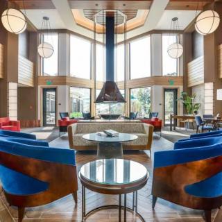 A modern lobby with stylish furniture and ample natural light.