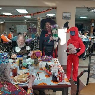 Residents and staff celebrate Halloween together with festive costumes and decorations.