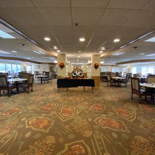 Spacious dining area with a central buffet setup and elegant carpet design.