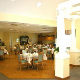 A spacious restaurant dining area with neatly arranged tables and chairs.
