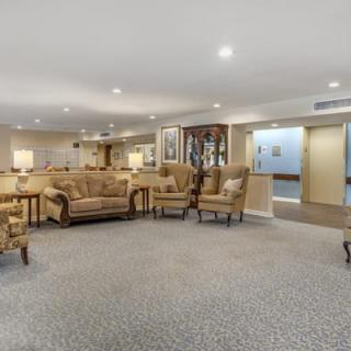 A spacious living room with comfortable seating and warm lighting.